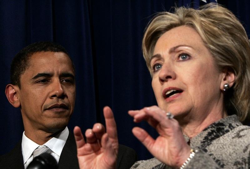 On Feb. 1, 2007, then-U.S. Sen. Hillary Clinton (D-NY) speaks on the passage of the minimum wage bill as then-Sen. Barack Obama (D-IL) looks on at the U.S. Capitol in Washington, DC.