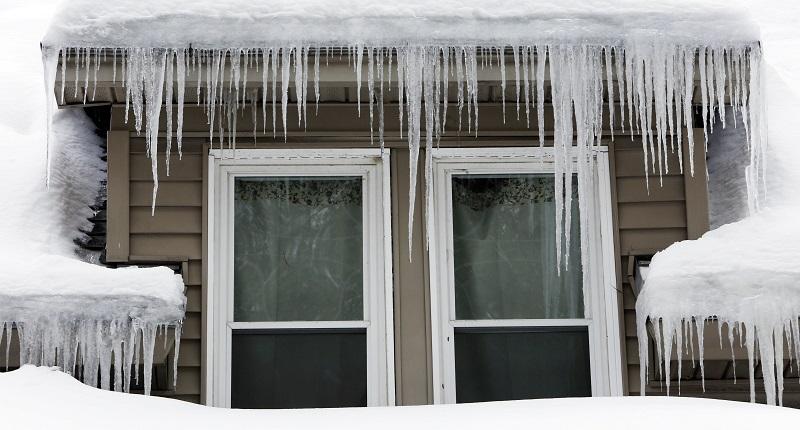 In this Feb. 4, 2015 file photo, icicles hang from a home in Sutton, N.H.