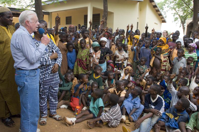 President Jimmy Carter addresses Ghanaian children outside Savelugu Hospital, asking "Who here has had Guinea worm disease?" Feb. 2007