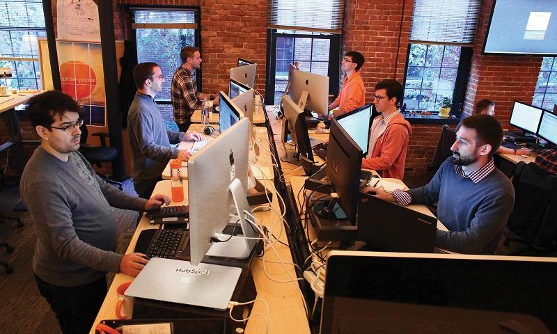 HubSpot employees work at their standing desks, on Monday, October 27, 2014.