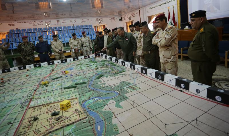 Iraqi Defence Minister Khaled al-Obeidi (R 5) gives the detail of an operation on the map on Feb. 26. The Iraqi army are preparing for an operation that will be carried out against the Islamic State.