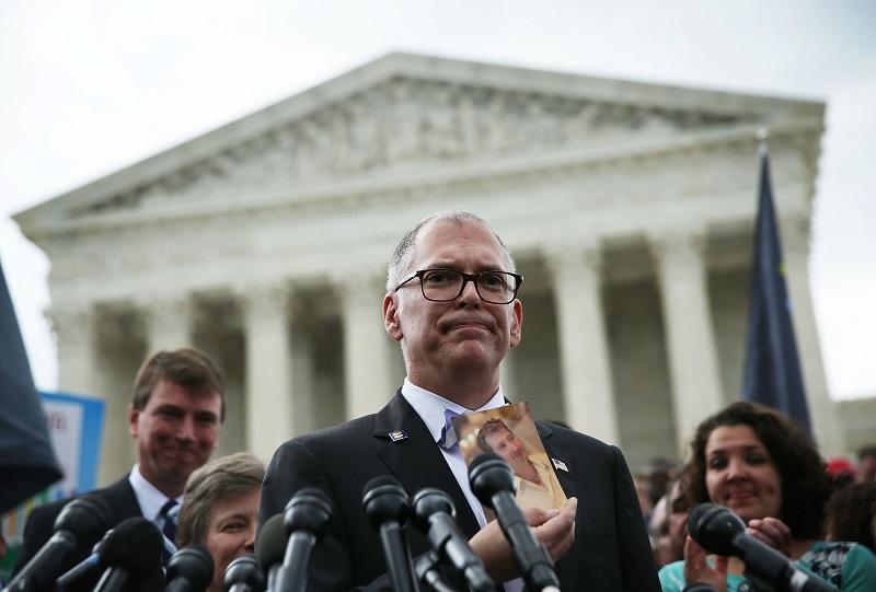 Plaintiff Jim Obergefell holds a photo of his late husband John Arthur as he speaks to members of the media after the U.S. Supreme Court handed down a ruling regarding same-sex marriage June 26, 2015
