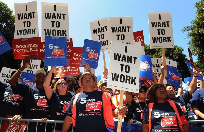 Americans hold up 'I want to work' placards as they join a protest of several thousand people demanding jobs outside City Hall in Los Angeles on August 13, 2010.