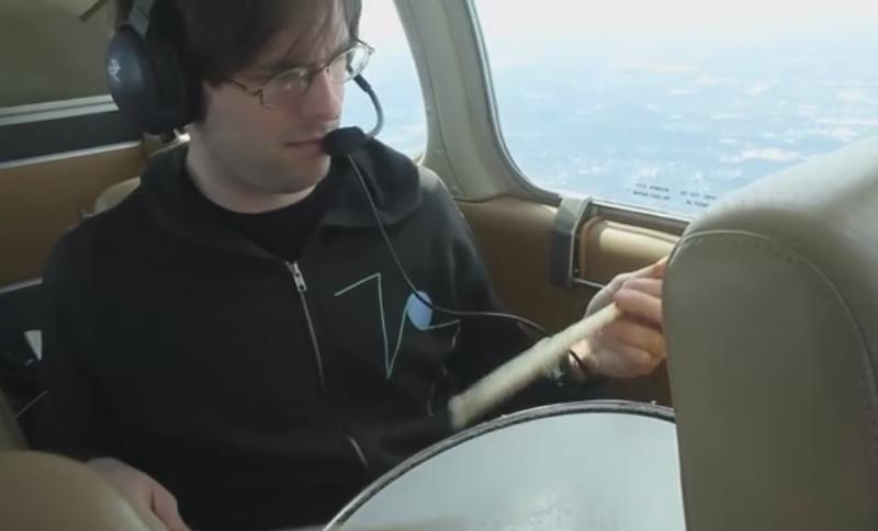 Kid Millions (aka John Colpitts), air-drumming, from a 4-seater plane