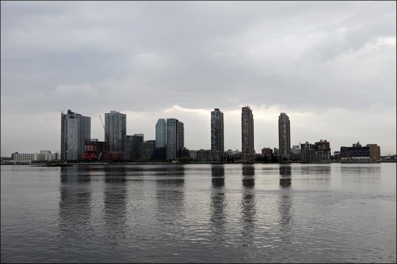 A view (as seen from Manhattan's East Side, across the Hudson River) of the Long Island City Skyline with the famed Pepsi-Cola sign (left) and the under-construction 25-story apartment tower.