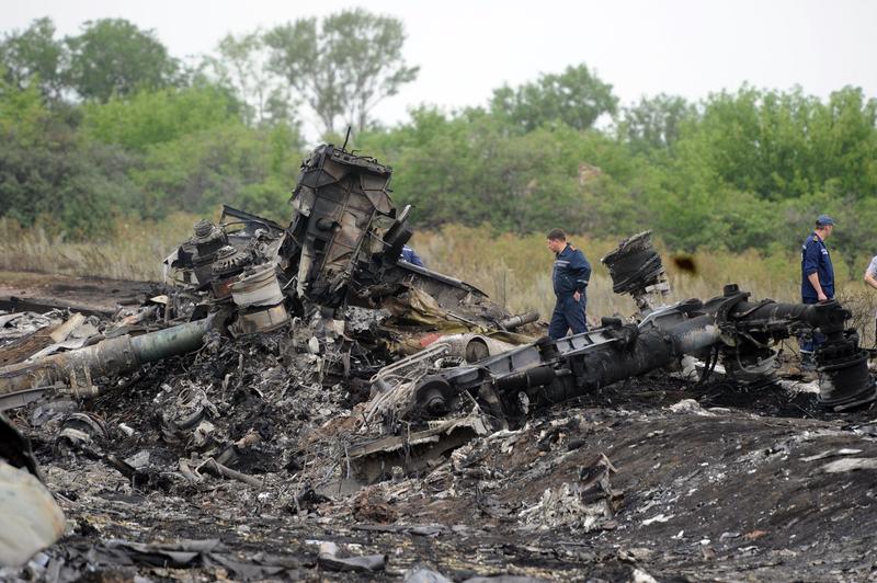 Rescuers stand on July 18, 2014 on the site of the crash of a Malaysian airliner carrying 298 people from Amsterdam to Kuala Lumpur, near the town of Shaktarsk, in rebel-held east Ukraine.