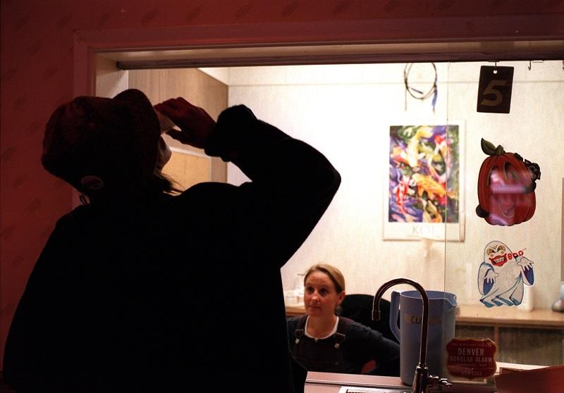 A client of the ARTS Outpatient Clinic in Denver, CO takes his dose of methadone issued by RN Mary Sinden.