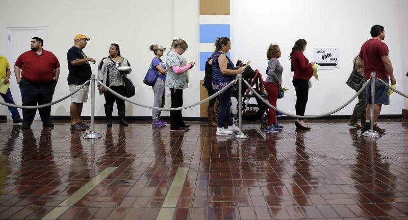 Voters wait in line to cast ballots at an early polling site, Friday, Nov. 4, 2016, in San Antonio. Friday is the last day of early voting in Texas. The polls will reopen on Election Day, Nov. 8.