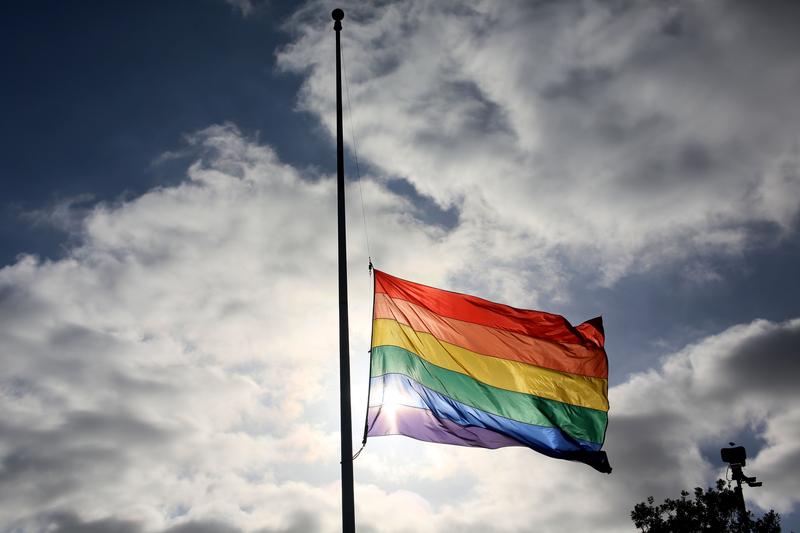 A pride flag stands a half mast during a memorial service in San Diego, California on June 12, 2016, for the victims of the Orlando Nightclub shooting.