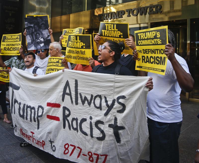 Anti-Trump protesters demonstrate outside a meeting between Donald Trump and minority Republicans at Trump Tower, Thursday Aug. 25, 2016, in New York.