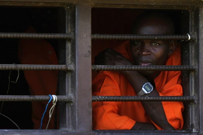 A prisoner looks out a window in the Golf Wing of the Nyanza Prison, where men convicted of genocide are housed April 3, 2014 in Nyanza, Rwanda.