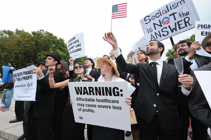 Members of the satirical street theater group 'Billionaires for Healthcare' perform as protesters against Pres. Barack Obama's health care plan and other policies gather in Washington on 9/12/2009.