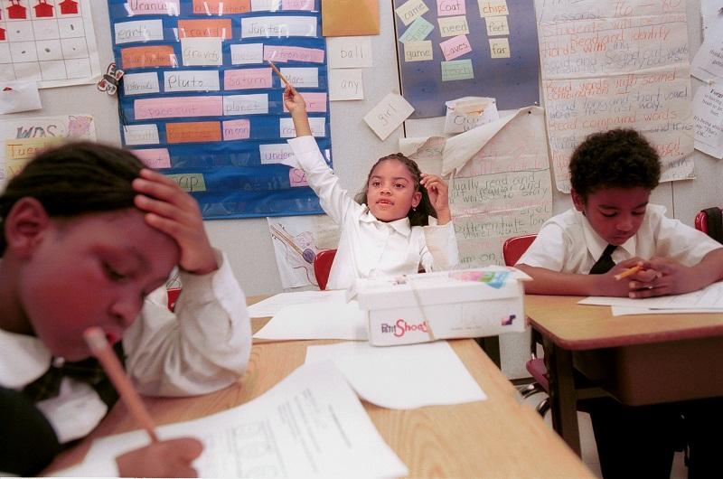Tasia Burroughs of Sisulu Children''s Adademy, a Harlem charter school, raises her hand during class Jun 21, 2000 in New York City.