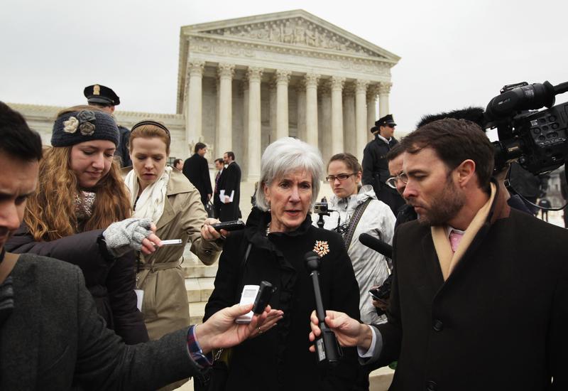 Former U.S. Secretary of Health and Human Services Kathleen Sebelius (C) speaks to members of the media as she comes out from the U.S. Supreme Court after oral arguments March 4, 2015 in Wash. D.C.
