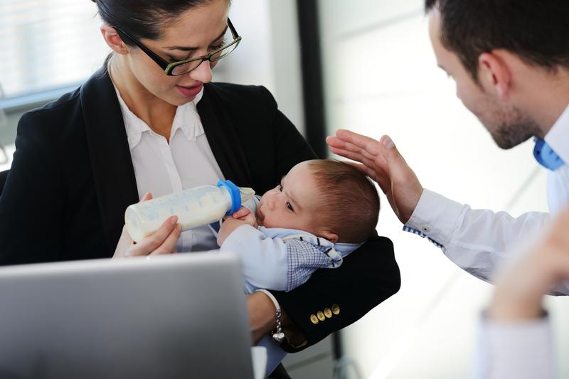 Business people taking care of a baby in the office