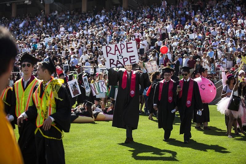 Graduating student, Paul Harrison, holds a sign in protest before the 125th Stanford University commencement ceremony on June 12, 2016 in Stanford, California.