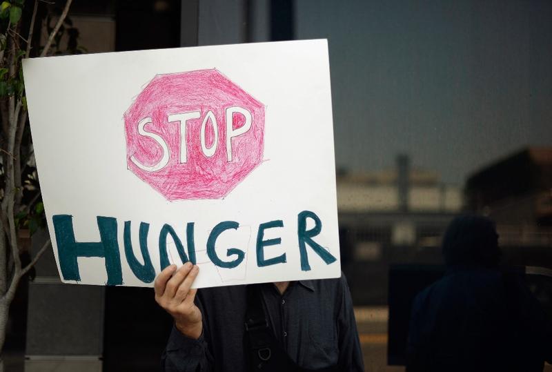 Members of Progressive Democrats of America and other activist hold a rally in front of Rep. Henry Waxman's office on June 17, 2013 in Los Angeles, California.