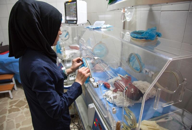 A Syrian nurse stands next to incubators with newborns who were evacuated by medical staff at a children's hospital to the basement following reported govt. bombardment within a few hundred meters