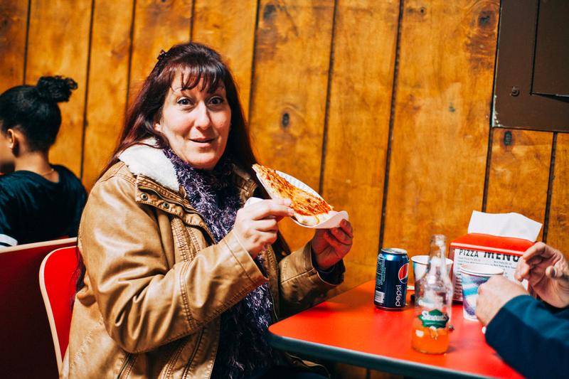 A happy gal dines at Tommy's Pizza in Throgs Neck.