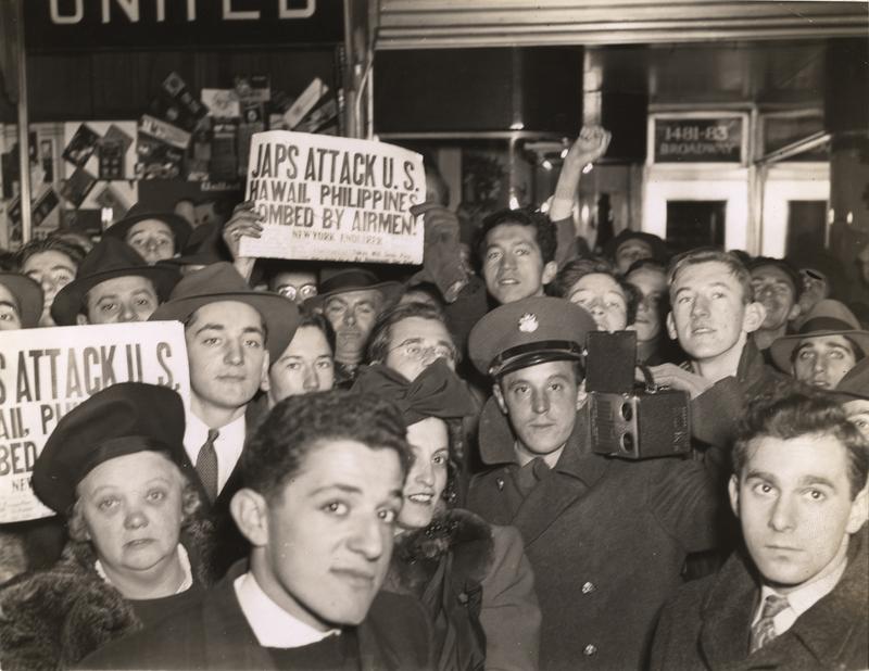 A crowd (with at least one member of the armed forces among them) gathers in Times Square after the Japanese attack on Pearl Harbor, New York, New York, December 8, 1941.