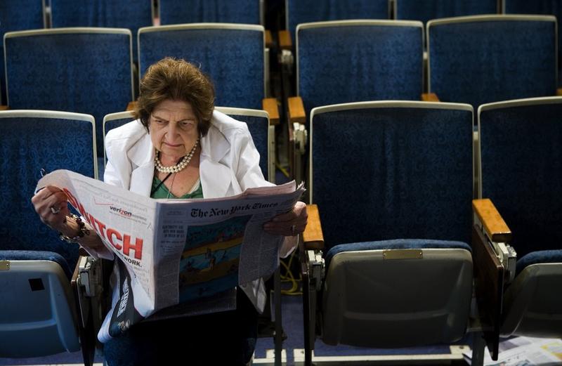 (FILE PHOTO) Senior White House Correspondent Helen Thomas reads the newspaper while sitting in her chair in the White House press room August 2, 2006 in Washington, DC.