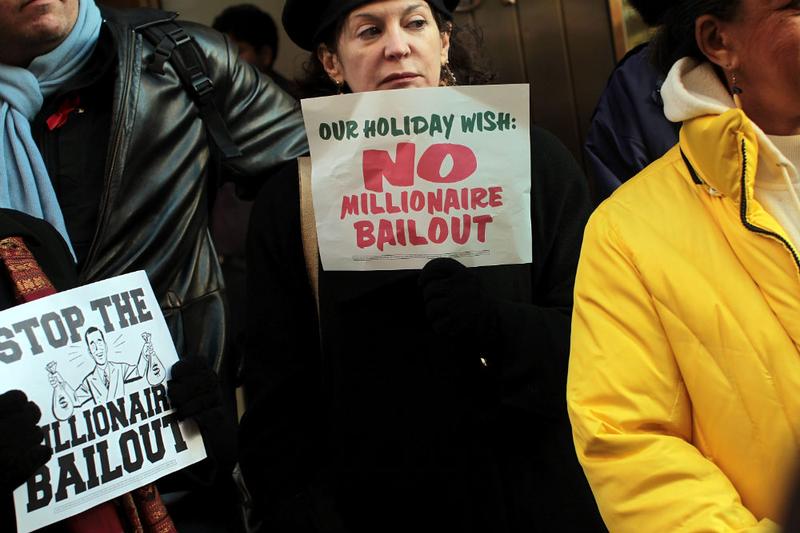 People attend a rally outside of the office of Sen. Charles Schumer (D-NY) to protest an extension of tax breaks for the wealthiest two percent of Americans on December 2, 2010 in New York City.