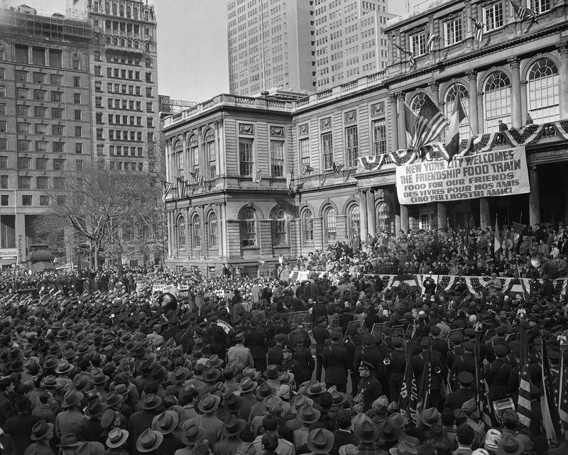 A crowd estimated by police at 25,000, at City Hall Plaza welcoming the Friendship Train to New York, Nov 18, 1947. The train, after a nation-wide tour collecting foodstuffs for needy Europeans.