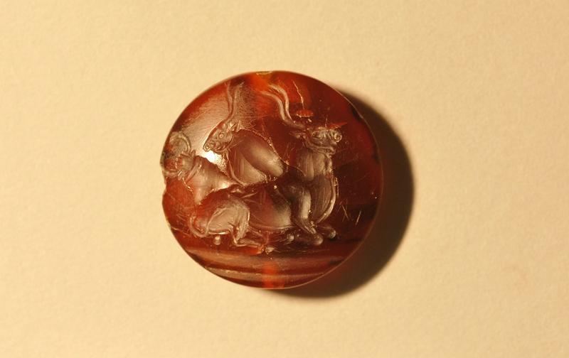 One of more than 45 seal stones found within the tomb, each bearing intricate designs. Long-horned bulls and, sometimes, human bull jumpers leaping over their horns are a common relief from the Minoan