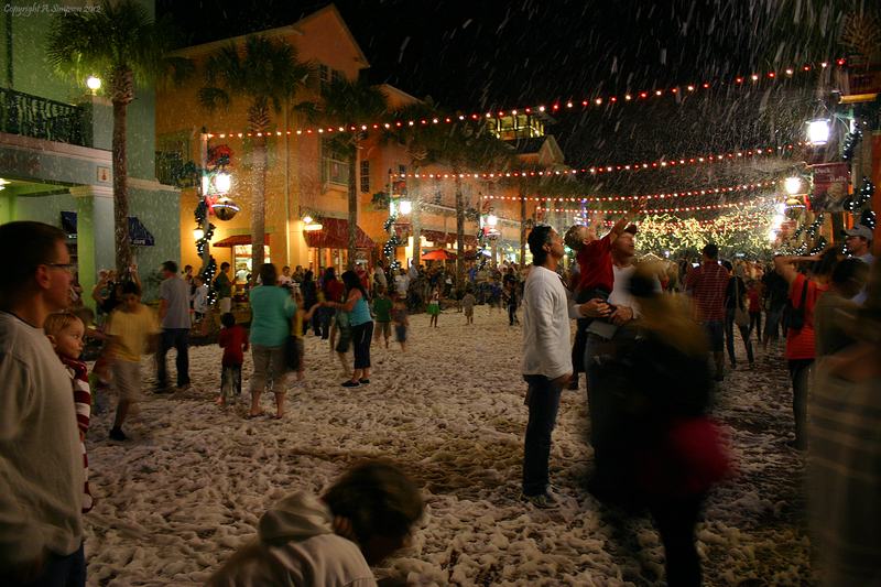 To celebrate the winter holidays, downtown Celebration is covered in 'snoap'  mdash; a soapy snow substitute that falls from the streetlamps