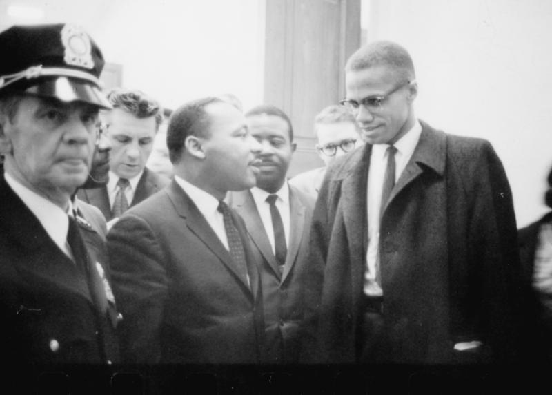 Martin Luther King and Malcolm X waiting for press conference